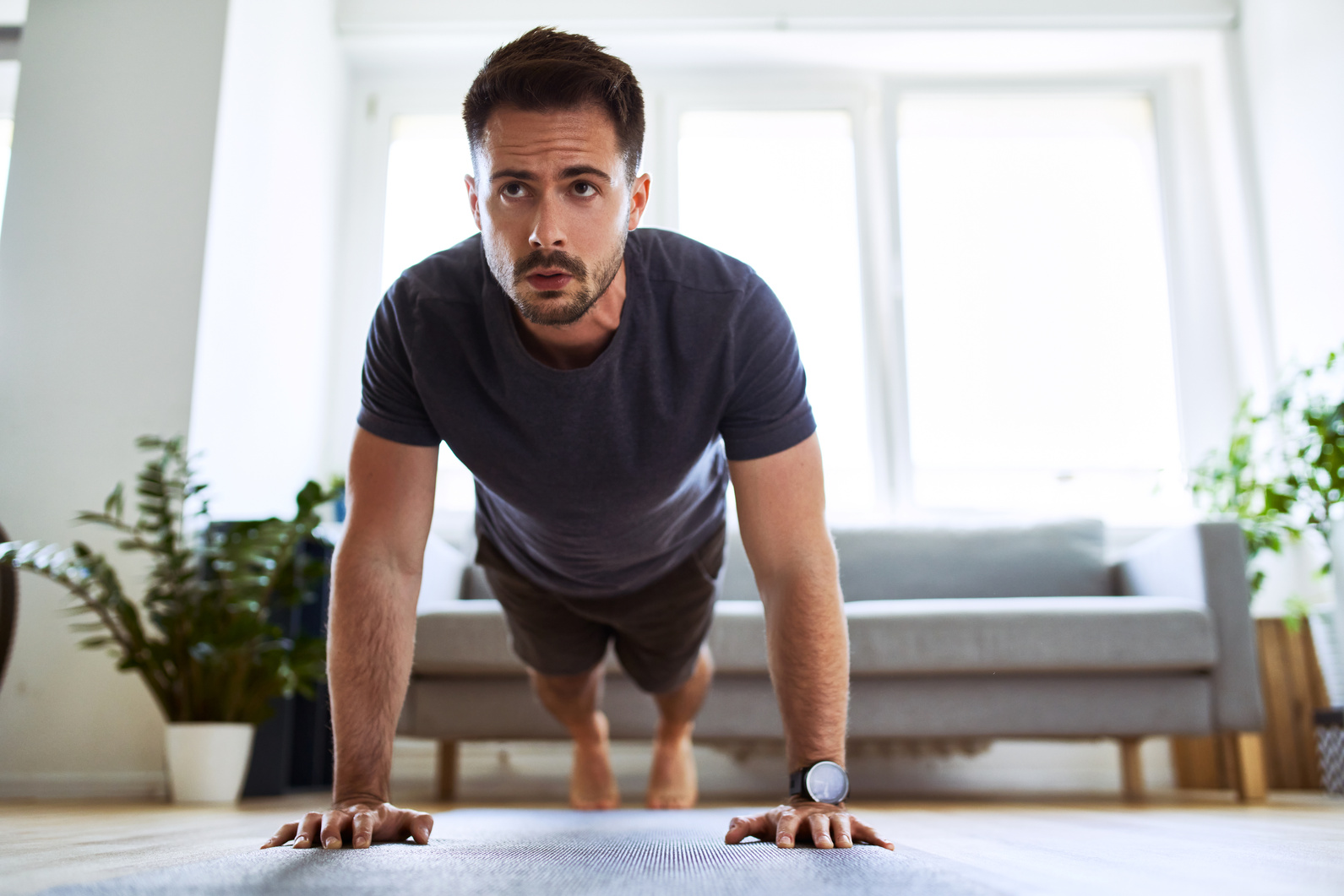 Man doing pushup exercise during home workout.